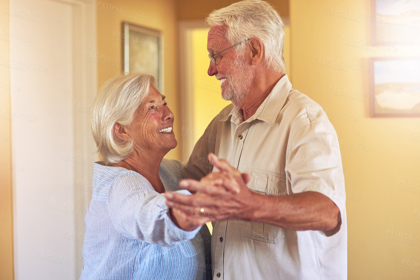 Buy stock photo Shot of a happy senior couple dancing together at home