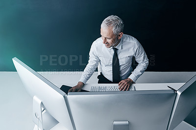 Buy stock photo High angle shot of a businessman working behind his computer in the office