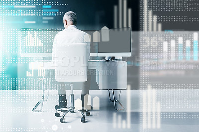 Buy stock photo Rearview shot of a businessman working at his desk in the office