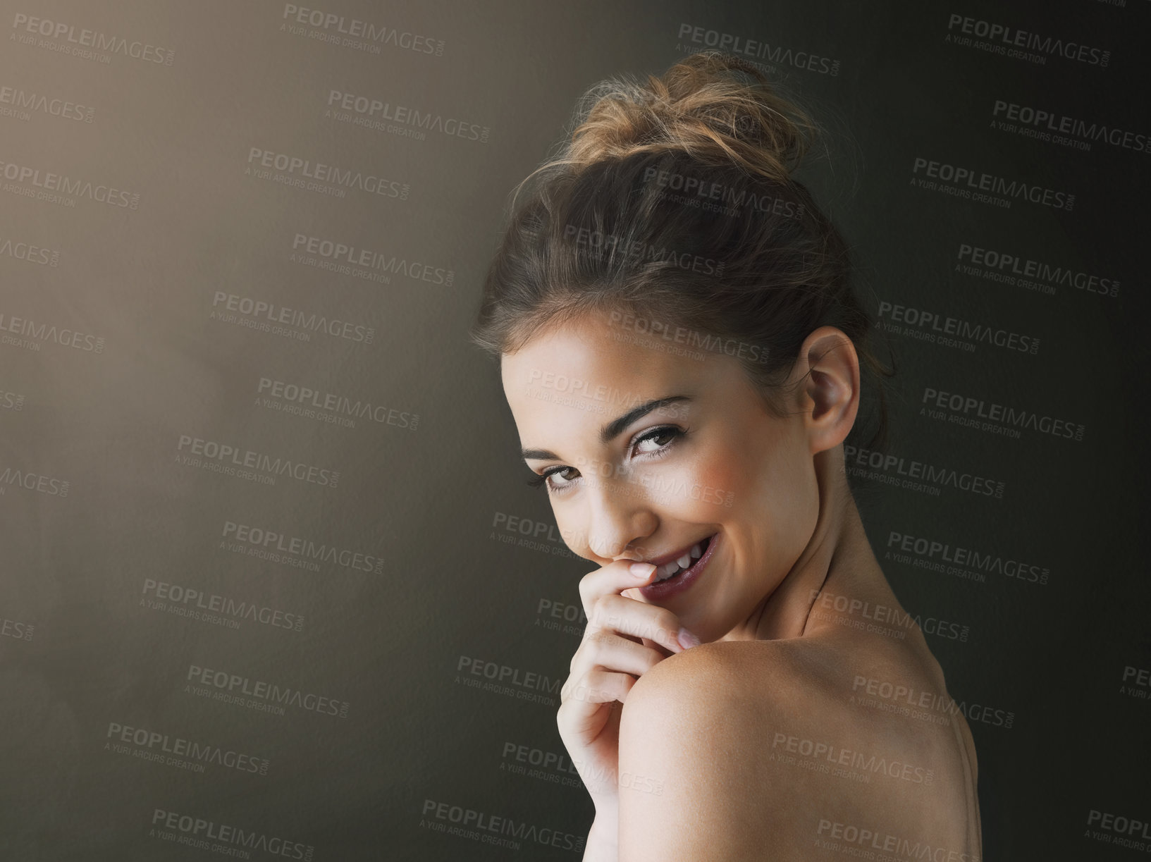 Buy stock photo Studio shot of a beautiful young woman posing against a brown background