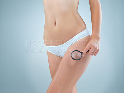 Buy stock photo Beauty, body and magnifying glass with woman in underwear on studio gray background for health or wellness. Cosmetics, investigation and skincare with leg of model in panties for cellulite search