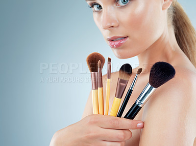 Buy stock photo Woman, studio and confident with makeup brushes for beauty and cosmetics in gray background. Female person, aesthetics and mockup on portrait with tools or kit for grooming, foundation and glow