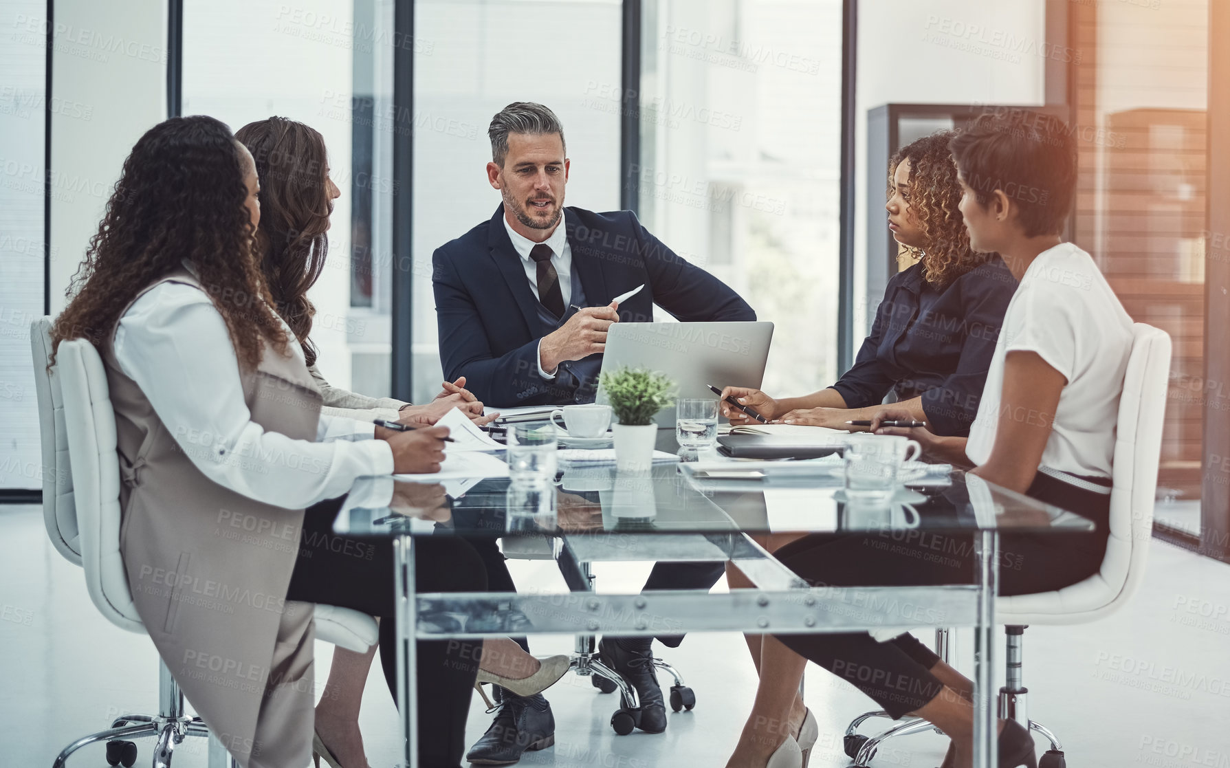 Buy stock photo Shot of a group of colleagues having a meeting in a modern office