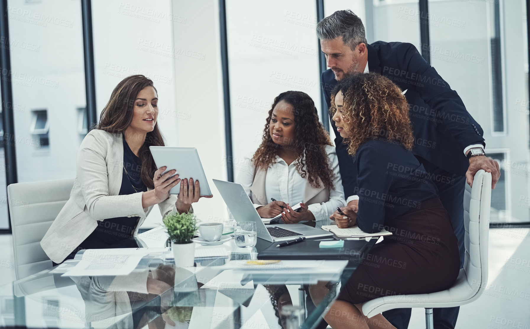 Buy stock photo Shot of a group of colleagues having a meeting in a modern office