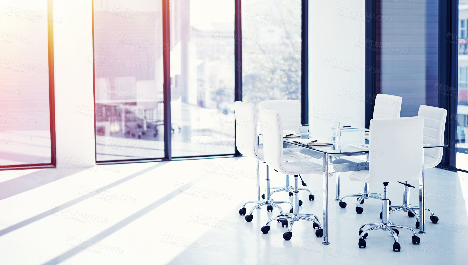 Buy stock photo Shot of an empty boardroom furnished with a table and chairs