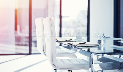 Buy stock photo Shot of an empty boardroom furnished with a table and chairs