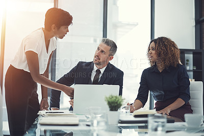 Buy stock photo Shot of a group of businesspeople having a meeting in the boardroom