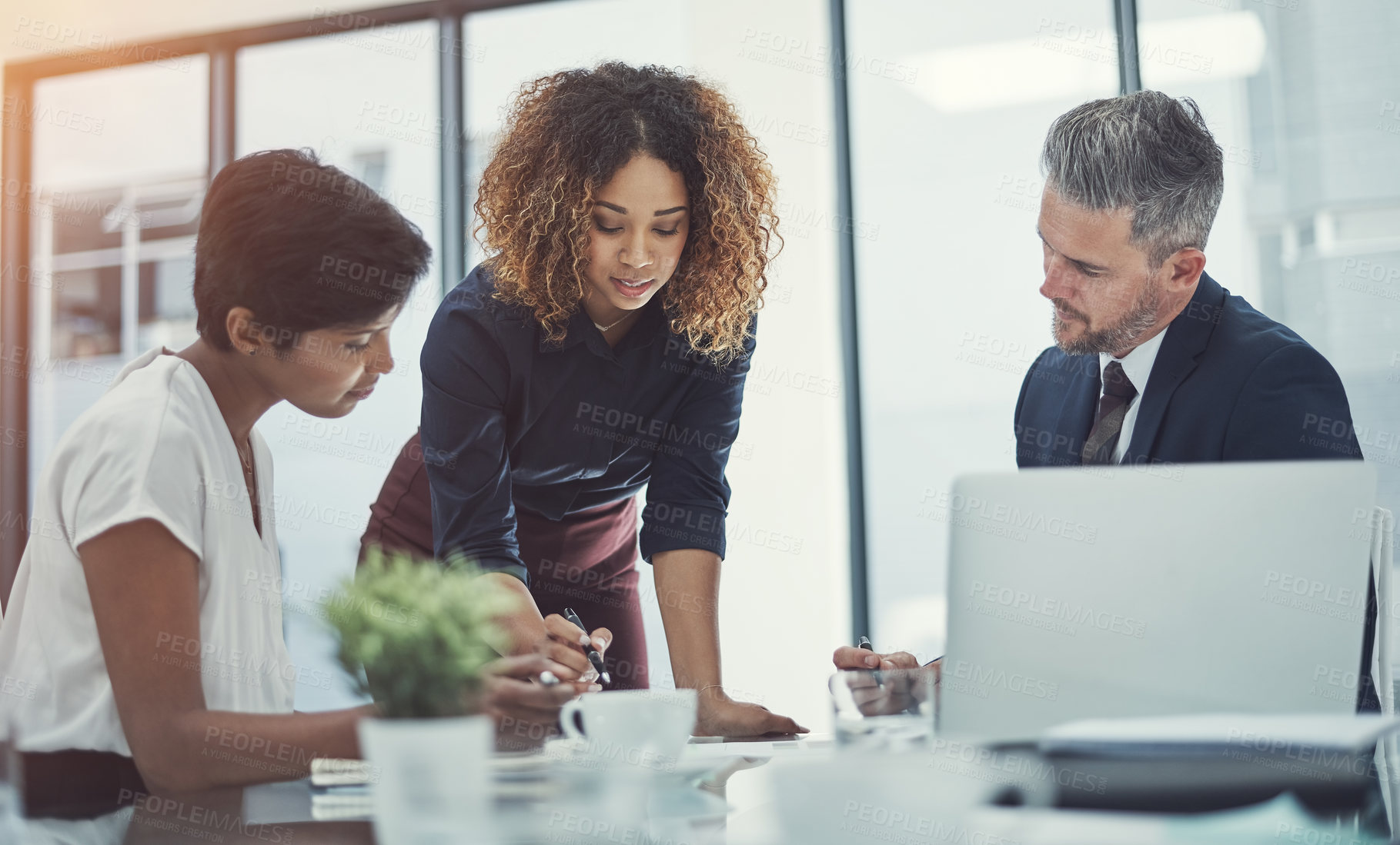 Buy stock photo Shot of a group of businesspeople having a meeting in the boardroom