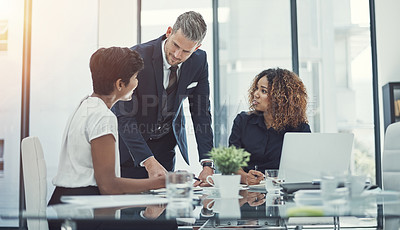 Buy stock photo Shot of a group of businesspeople having a meeting in the boardroom