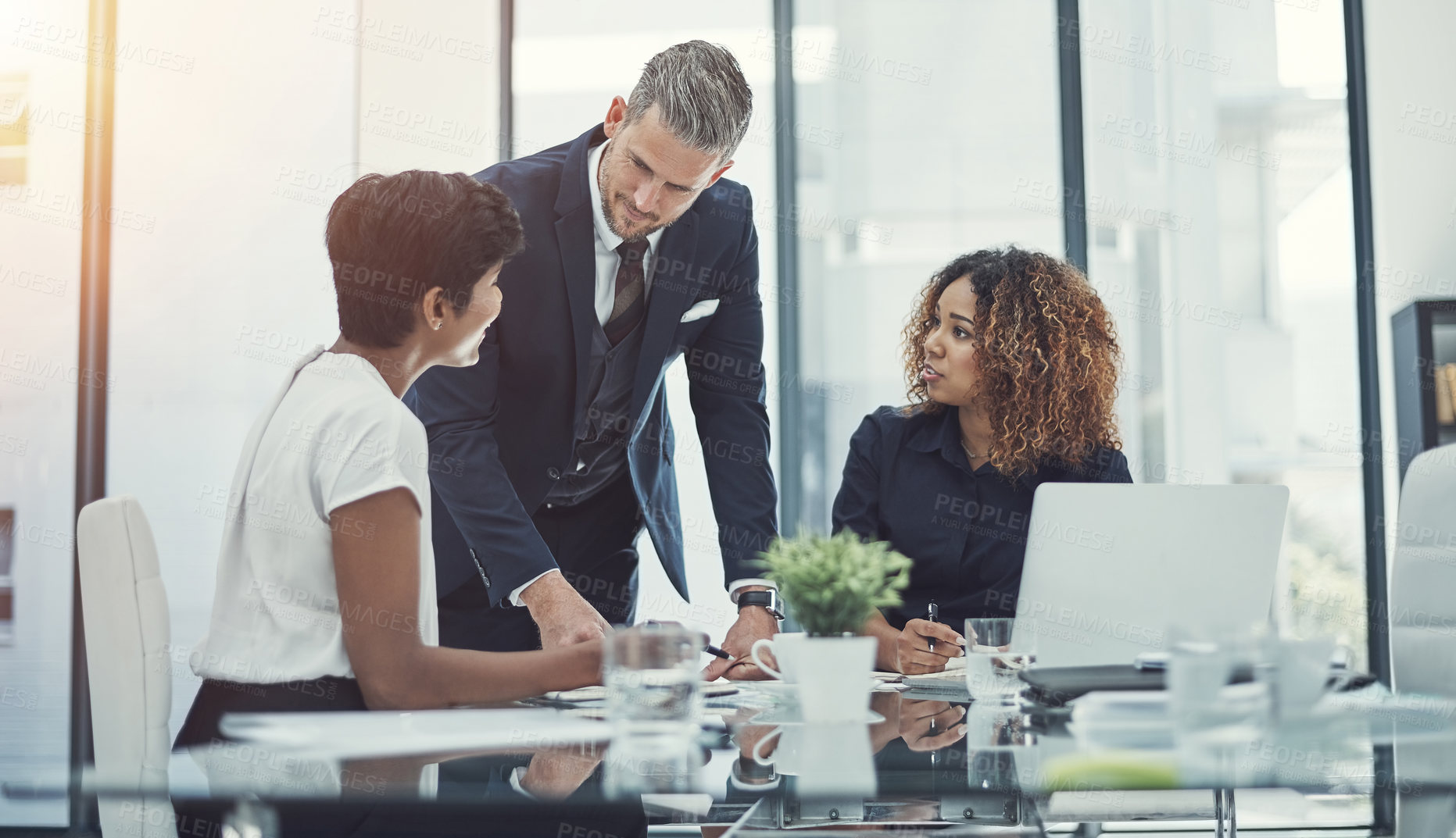 Buy stock photo Shot of a group of businesspeople having a meeting in the boardroom