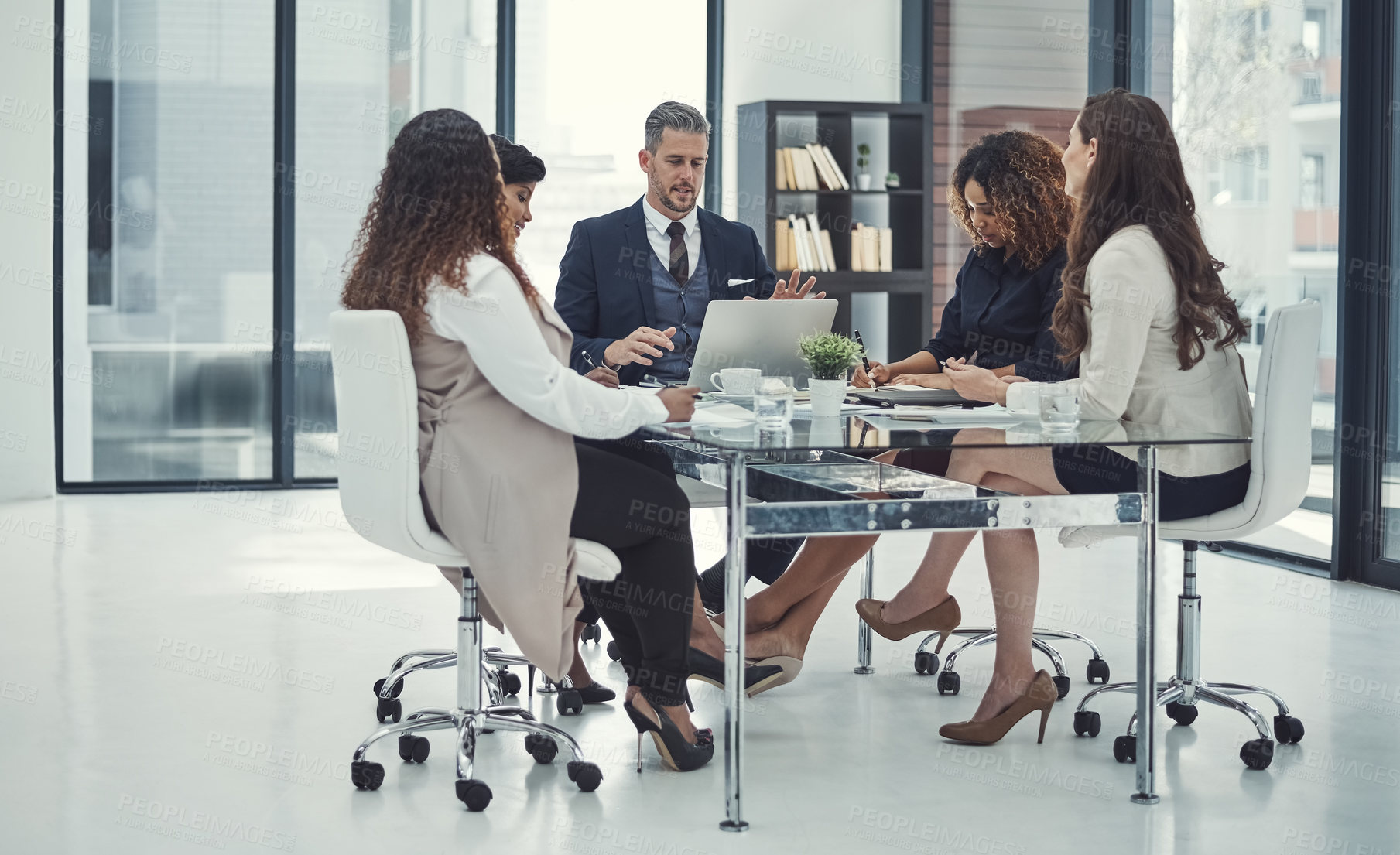 Buy stock photo Shot of a group of colleagues having a meeting in a modern office