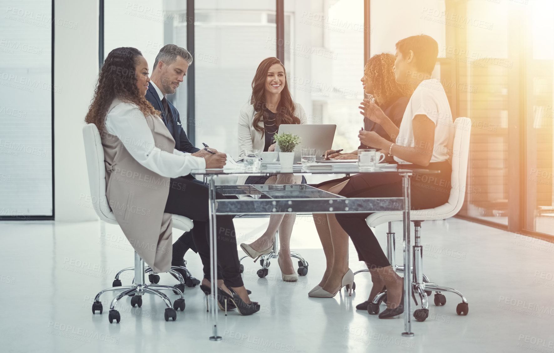 Buy stock photo Shot of a group of colleagues having a meeting in a modern office