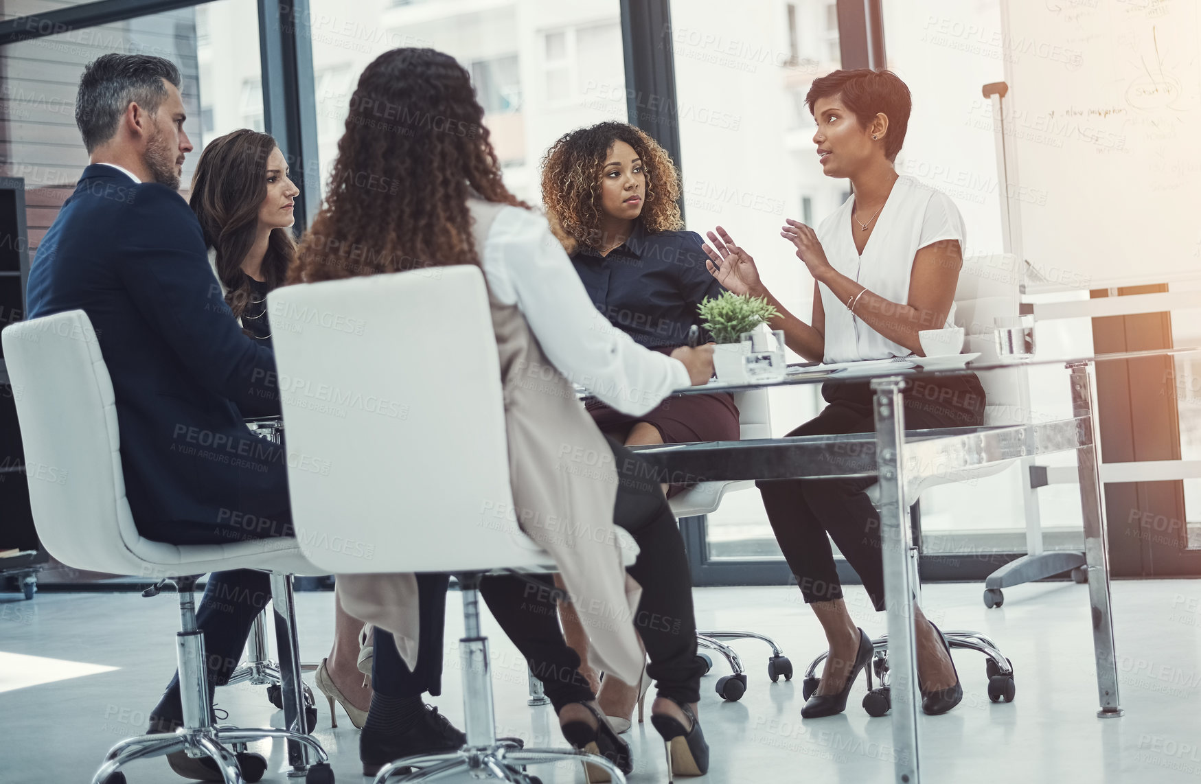 Buy stock photo Shot of a group of colleagues having a meeting in a modern office