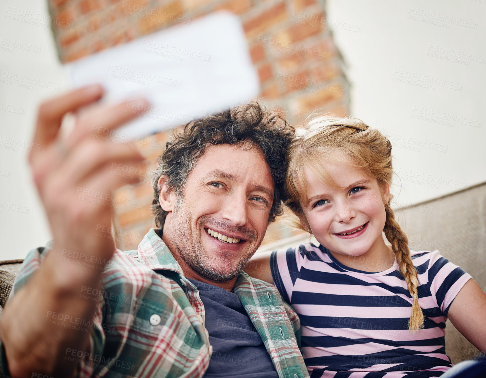 Buy stock photo Happy father, daughter and relax with selfie for photography, picture or memory together at home. Dad, child or little girl with smile for bonding, holiday or weekend moment on lounge couch at house