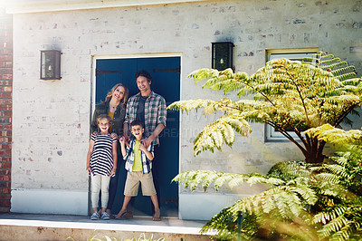 Buy stock photo Portrait of a happy family standing outside their home
