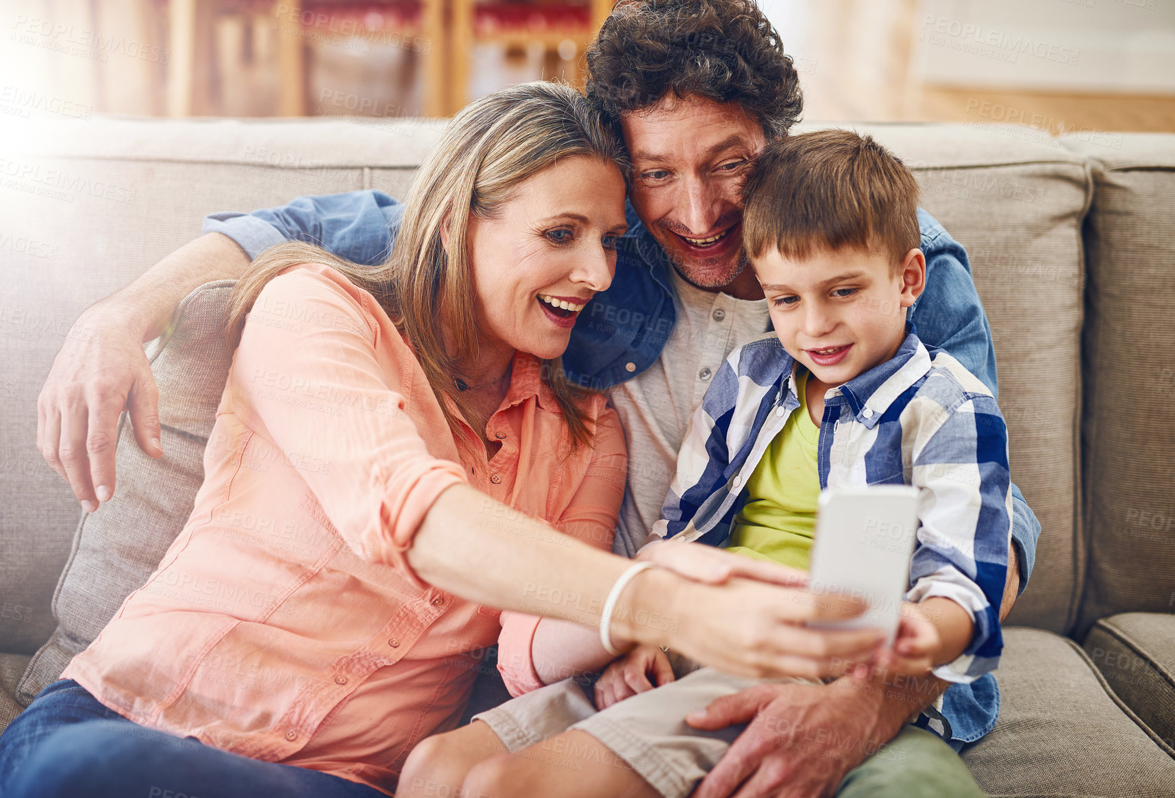 Buy stock photo Happy family, relax and sofa with selfie for photography, picture or memory together at home. Mother, father and young son with smile for bonding, holiday or weekend moment on lounge couch at house