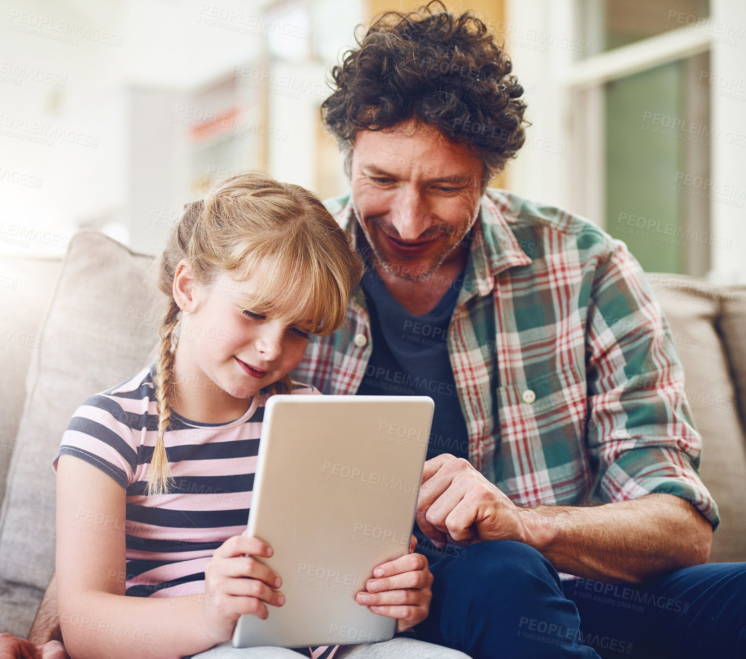 Buy stock photo Home, father and girl with tablet in sofa in smile for  elearning, child development and knowledge for growth. Parent, kid and support with help or teaching for educational game, entertainment or fun