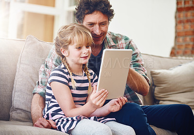 Buy stock photo Home, dad and daughter with tablet in sofa with smile for  elearning, child development and knowledge with growth. Parent, kid and support with help, teaching and educational game for entertainment