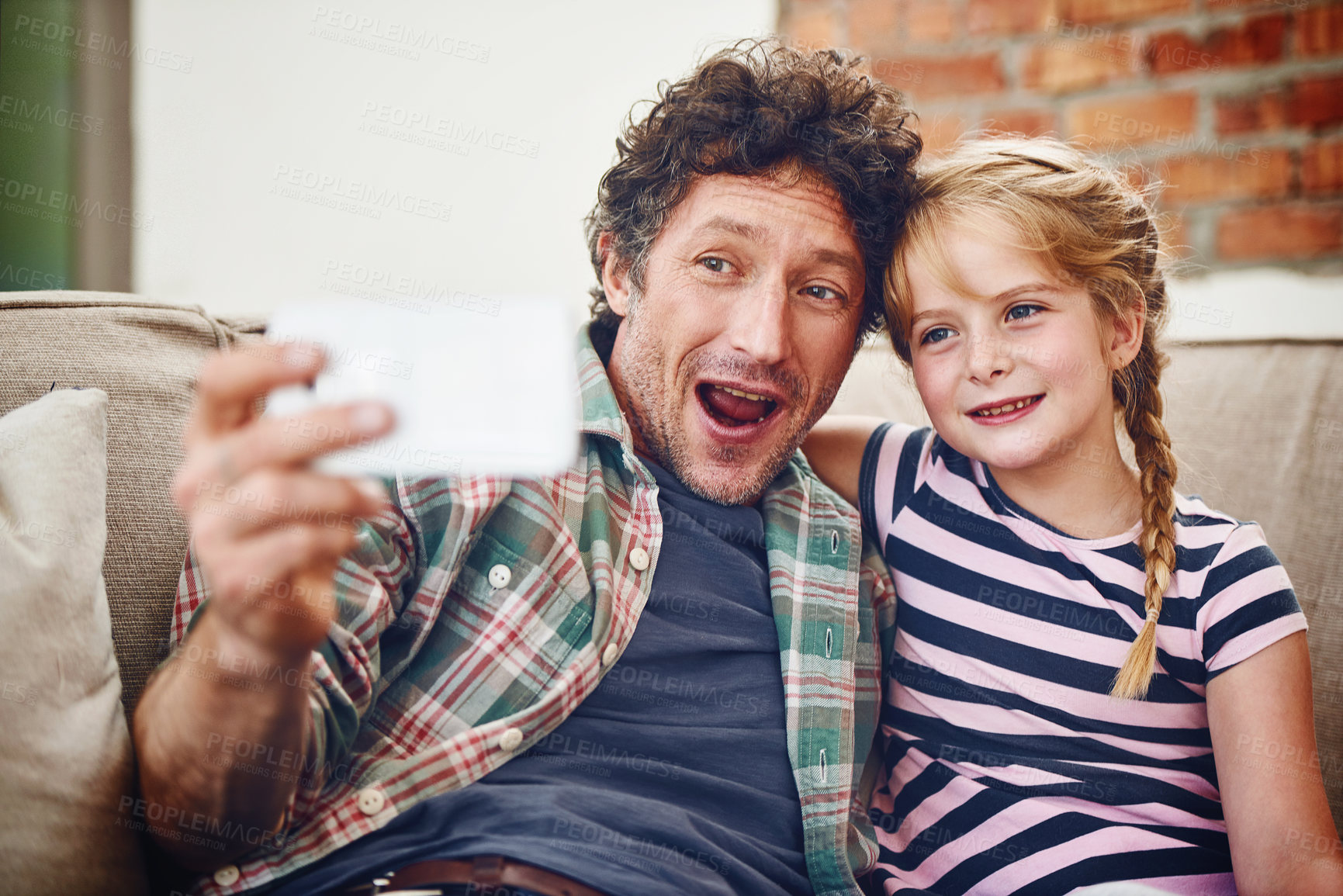 Buy stock photo Happy dad, little girl and relax with selfie for picture, photography or memory together at home. Father, daughter or child with smile for bonding, holiday or weekend moment on lounge couch at house