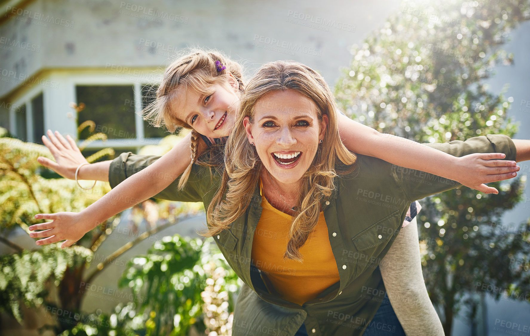 Buy stock photo Happy mother, portrait and piggyback with daughter for bonding, holiday or weekend in backyard at home. Mom, child or little girl with smile for flying, playing or support for outdoor day together