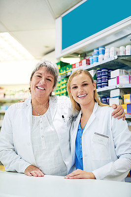 Buy stock photo Shot of two happy women working together in a pharmacy
