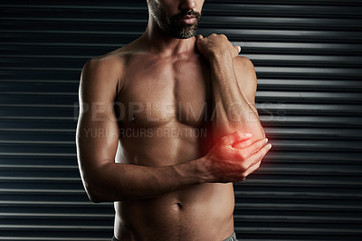 Buy stock photo Studio shot of a muscular young man with cgi highlighting an inflammation in his elbow