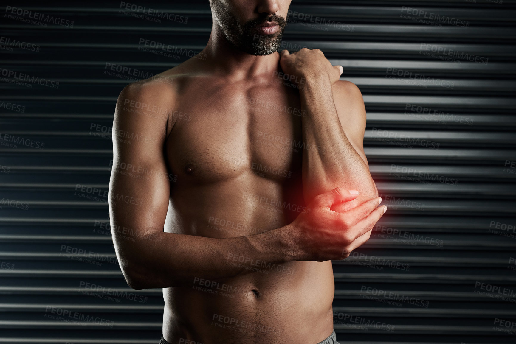 Buy stock photo Studio shot of a muscular young man with cgi highlighting an inflammation in his elbow