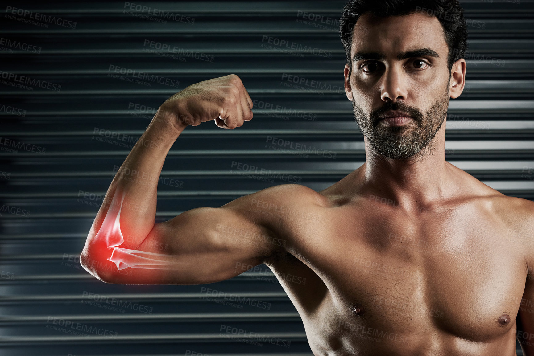 Buy stock photo Studio portrait of a muscular young man flexing his bicep with cgi highlighting his elbow