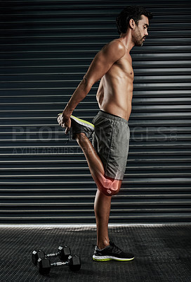 Buy stock photo Studio shot of a muscular young man stretching his calf and knee highlighted in cgi