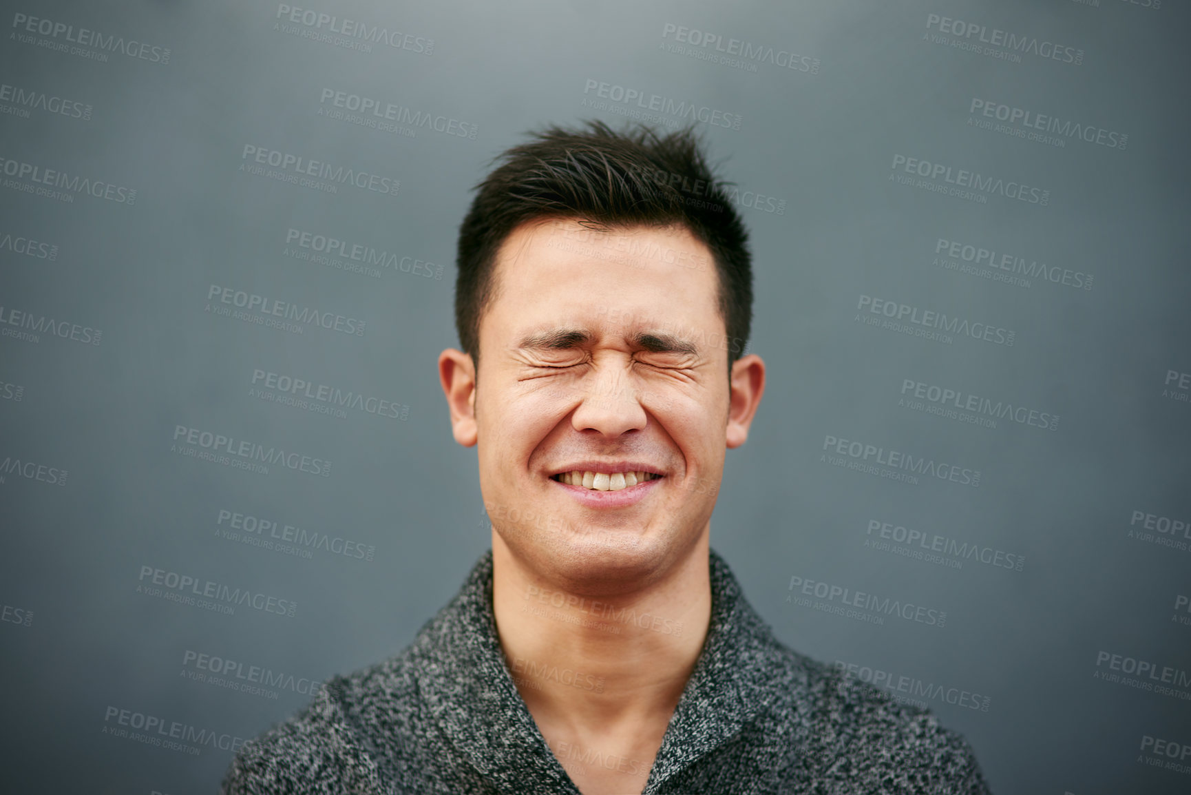 Buy stock photo Studio shot of a young man making a face against a grey background