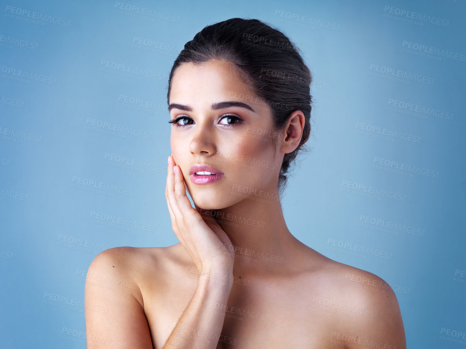 Buy stock photo Cosmetics, skincare and portrait of woman in studio with natural beauty, confidence and luxury makeup on face. Dermatology, facial care and girl with glow, shine and healthy skin on blue background