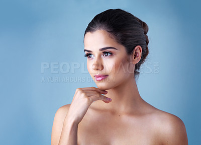 Buy stock photo Face, skincare and woman in studio with natural beauty, confident makeup and luxury cosmetics. Dermatology, facial care and girl thinking with wellness, relax and healthy skin glow on blue background