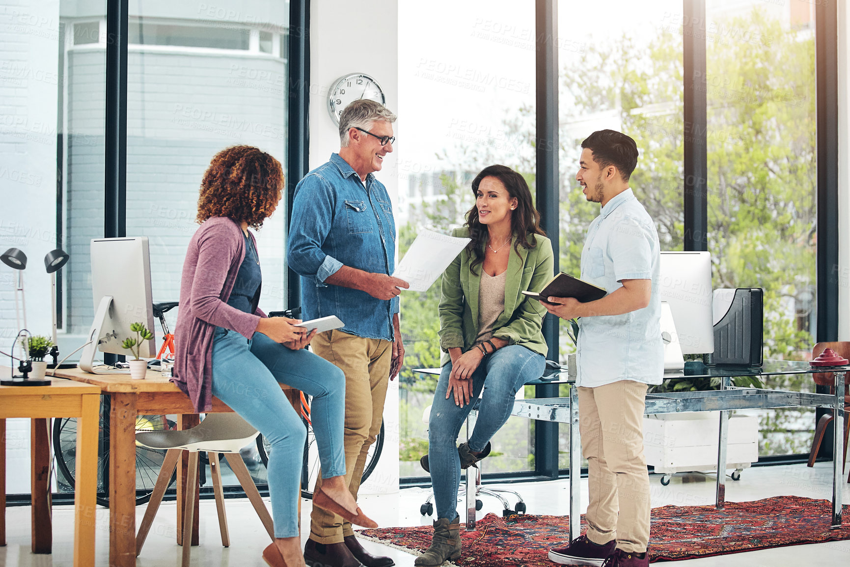 Buy stock photo Shot of a group of creative colleagues exchanging ideas in their office