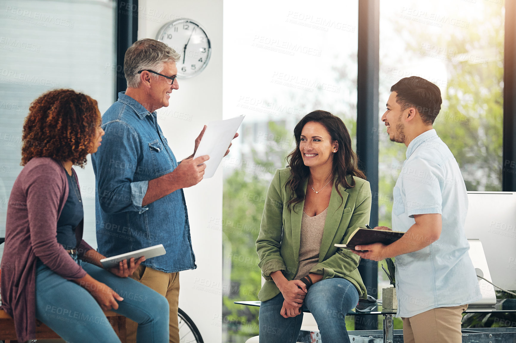 Buy stock photo Shot of a group of creative colleagues exchanging ideas in their office