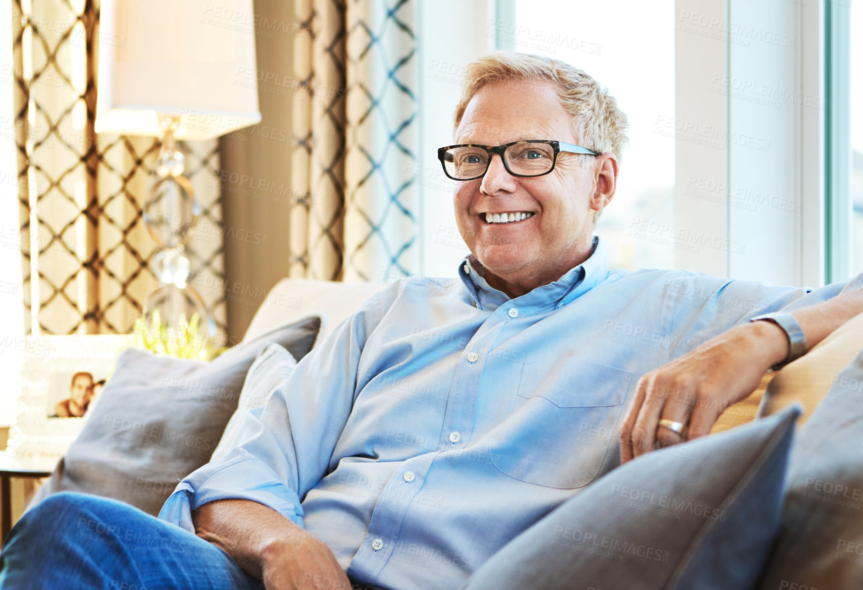 Buy stock photo Thinking, happy or mature man on sofa to relax with calm on living room couch at home for resting. Ideas, glasses or senior male person with smile, peace or wellness in retirement, lounge or house