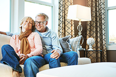 Buy stock photo Relax, happy and old couple on sofa in home for bonding, healthy relationship and marriage. Retirement, hug and senior man and woman on couch for love, commitment and fun together in living room