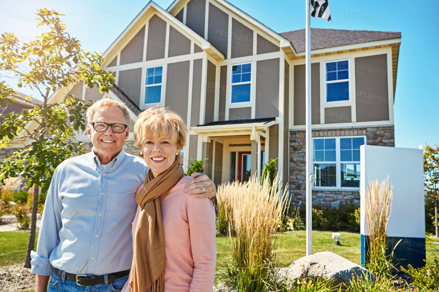 Buy stock photo Portrait of a happy senior couple posing outside their new home