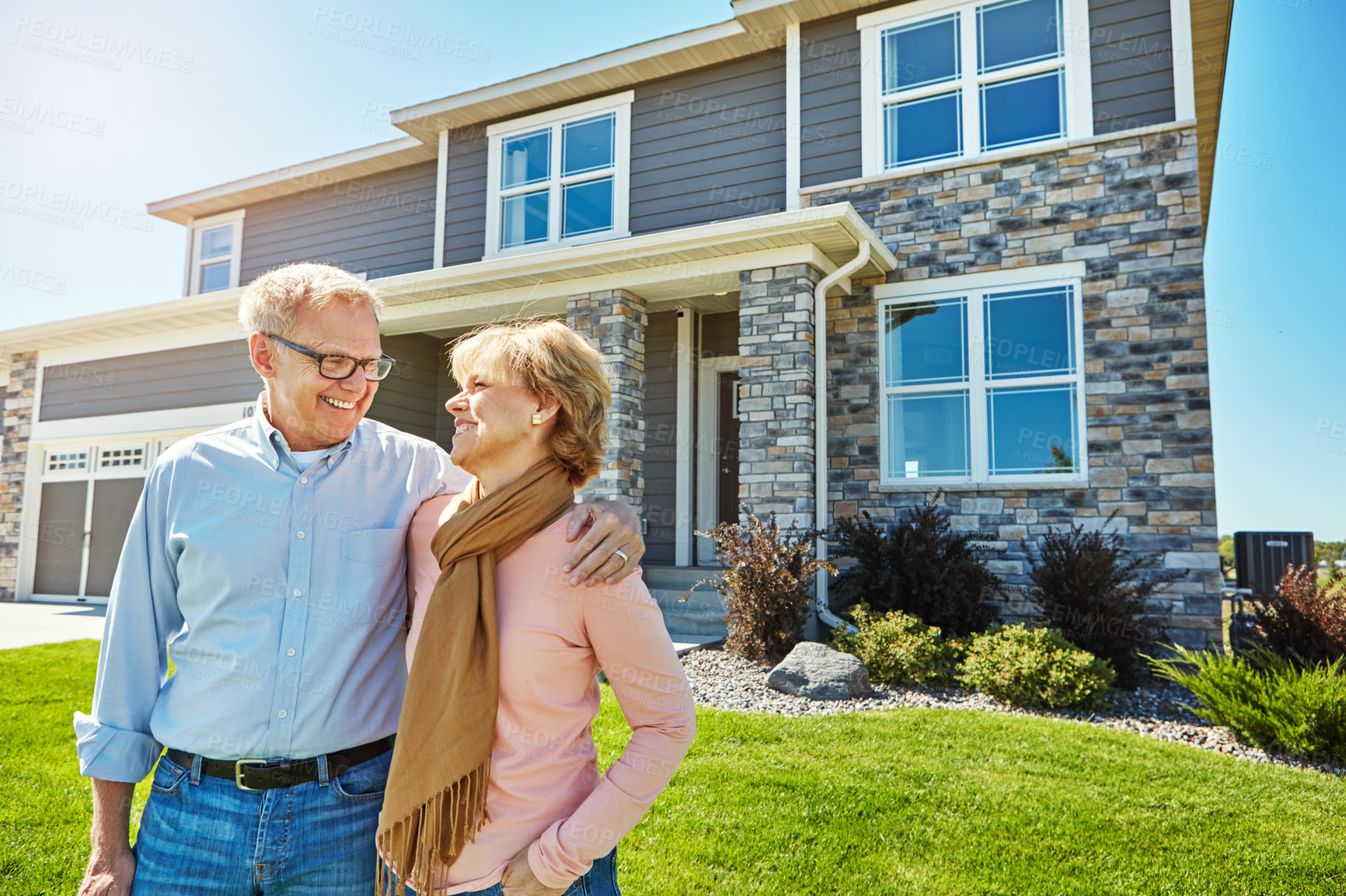 Buy stock photo Shot of a happy senior couple posing outside their new home