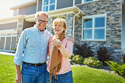 Buy stock photo Portrait of a happy senior couple posing outside their new home