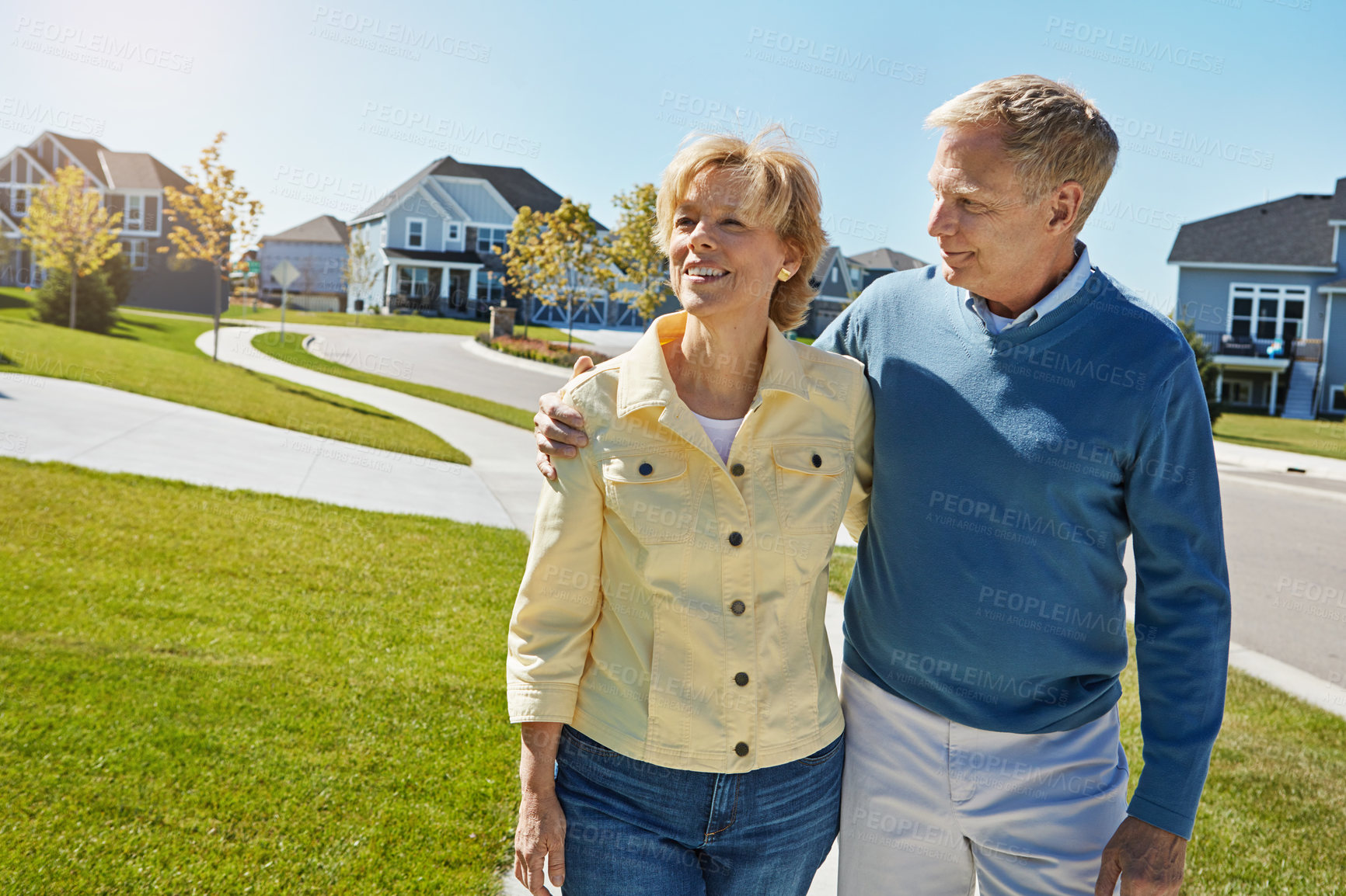 Buy stock photo Shot of a happy senior couple waking around their neighborhood together