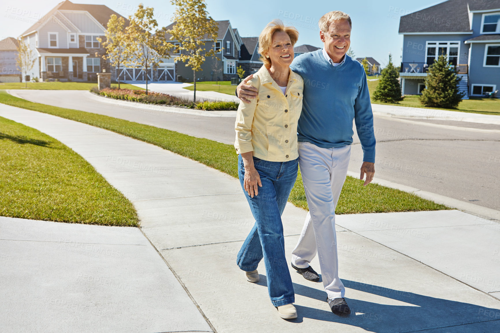 Buy stock photo Shot of a happy senior couple waking around their neighborhood together