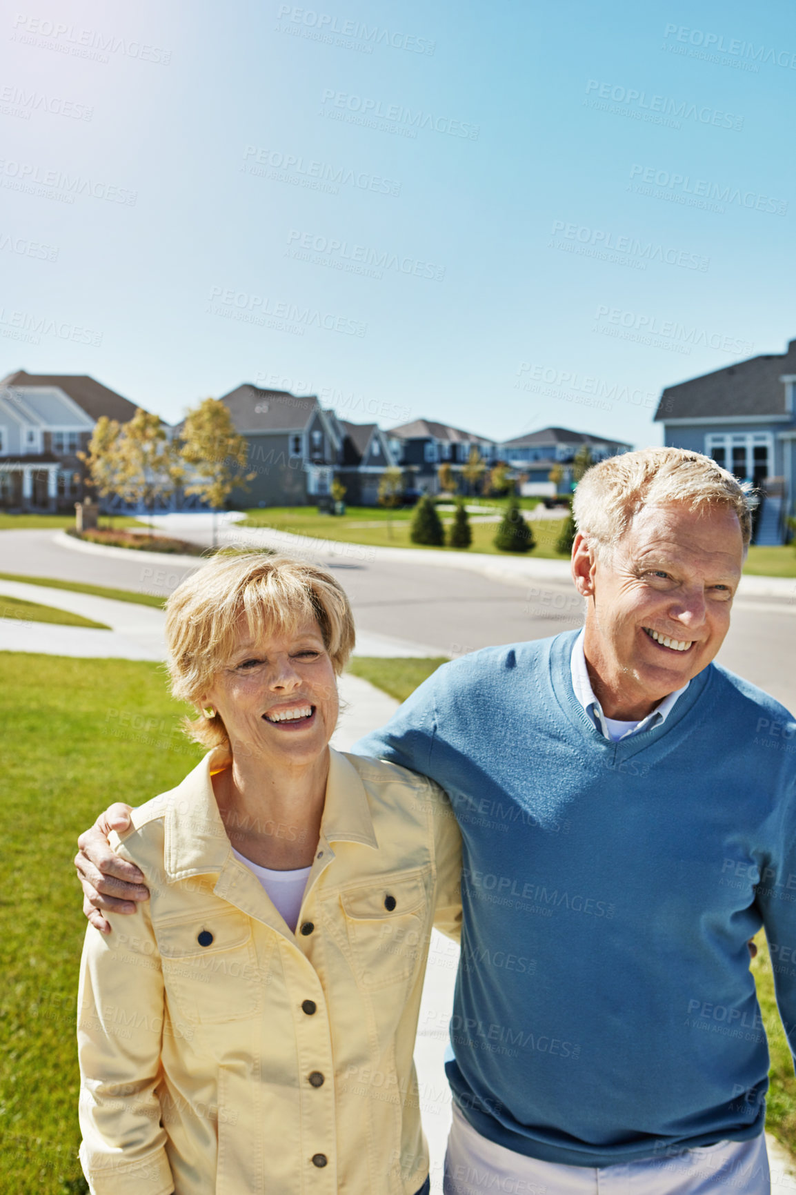 Buy stock photo Shot of a happy senior couple waking around their neighborhood together