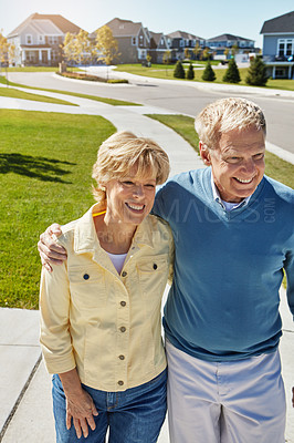 Buy stock photo Shot of a happy senior couple waking around their neighborhood together