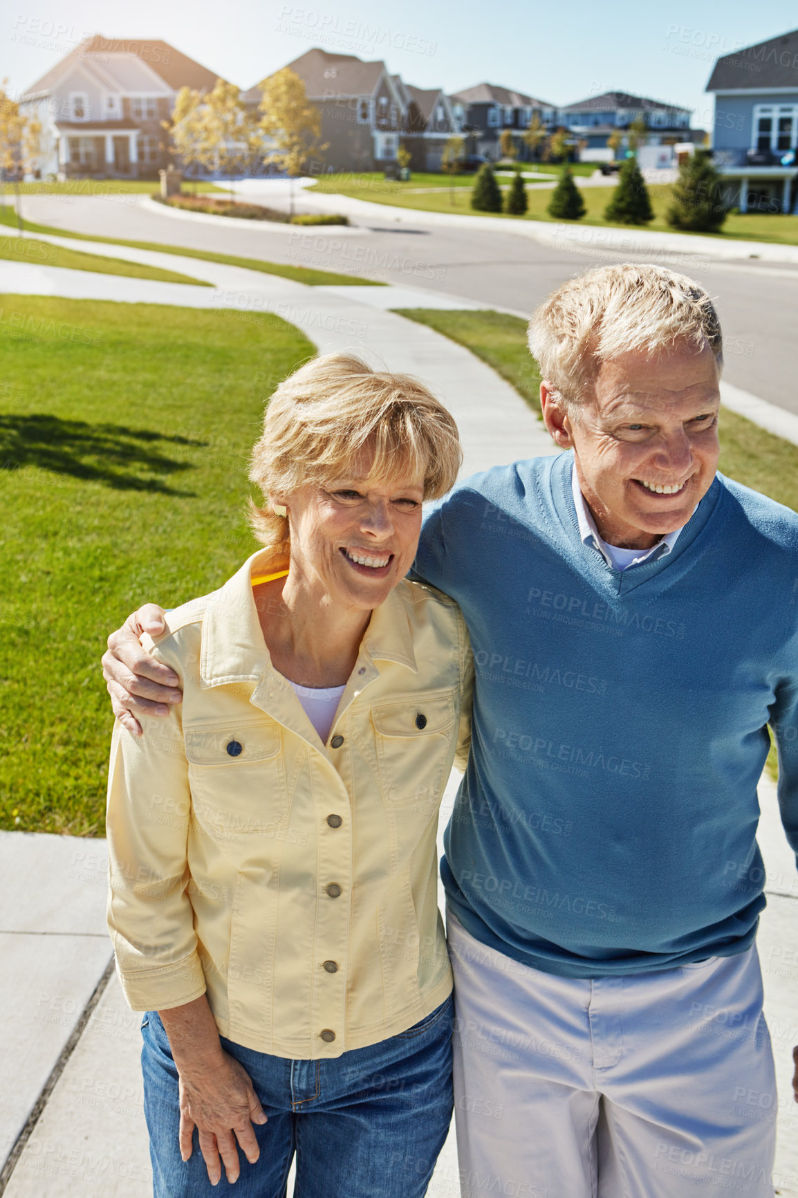 Buy stock photo Shot of a happy senior couple waking around their neighborhood together