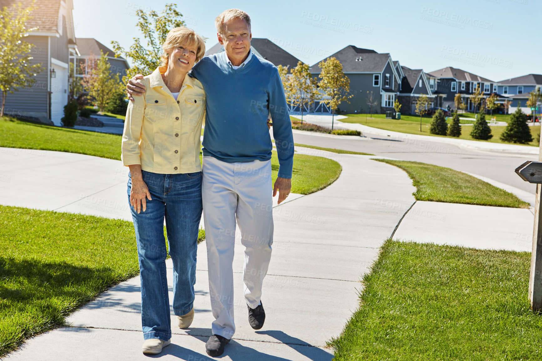 Buy stock photo Shot of a happy senior couple waking around their neighborhood together