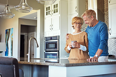 Buy stock photo Cropped shot of a mature couple having coffee in their kitchen