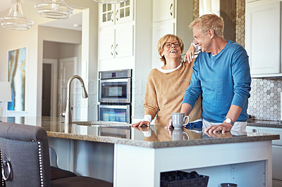 Buy stock photo Cropped shot of a mature couple having coffee in their kitchen