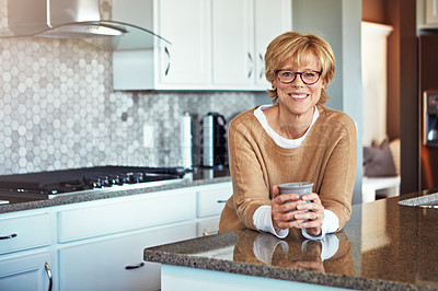 Buy stock photo Cropped portrait of a mature woman drinking coffee in her kitchen