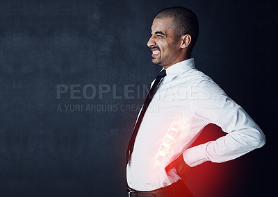 Buy stock photo Studio shot of a young businessman suffering with back pain highlighted in glowing red