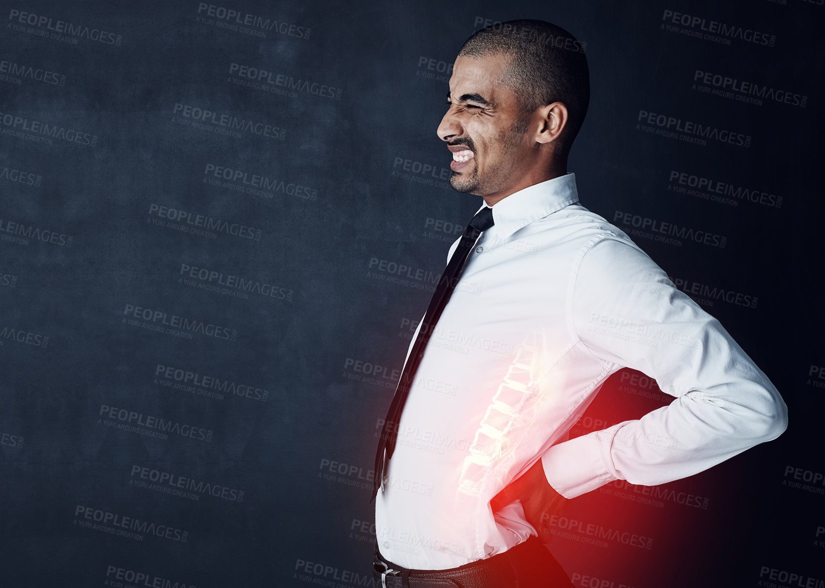 Buy stock photo Studio shot of a young businessman suffering with back pain highlighted in glowing red